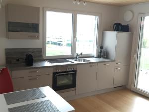 a kitchen with a sink and a refrigerator at Ferienwohnung Haag in Uhldingen-Mühlhofen