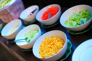 a group of bowls of food on a table at Regent Lodge Lampang in Lampang +32 photos
