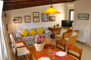 a living room with a couch and a table at Apartamentos Casa María in Cala Figuera
