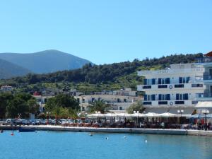 a group of buildings and a body of water at Poseidon in Ancient Epidauros +7 photos
