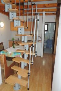a spiral staircase in a room with a table at Apartments Travarevic in Dubrovnik
