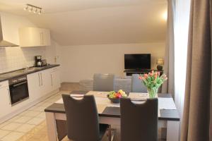 a kitchen and dining room with a table and chairs at Landhaus Lüdorf in Sinspert