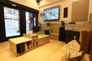 a living room with a tv on the wall at Yue Guang Homestay in Jian +29 photos