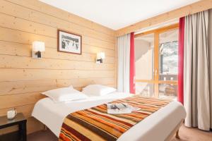 En eller flere senge i et værelse på Résidence Pierre & Vacances Le Tikal
