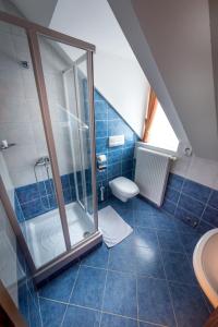 a bathroom with a shower and a toilet at Garni Hotel Pod Roglo Boharina 2 in Zreče