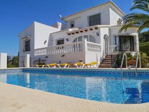 a white house with a swimming pool in front of it at Villa Sophie 4 - by Holiday Rentals Villamar in Benitachell