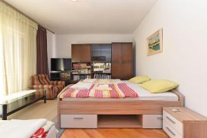 a bedroom with a bed and a living room at Apartments Josip 74 in Pula