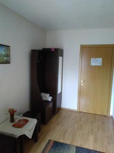 a living room with a door and a table and a room at Pensiunea SENA Focsani in Focşani