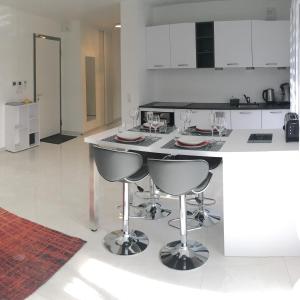 a kitchen with a island with chairs and a counter top at Carpe Diem in Annecy