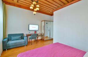 a bedroom with a bed and a table and chairs at Istanbul Life Hotel in Istanbul
