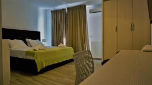 Postel nebo postele na pokoji v ubytování Hotel Ionian