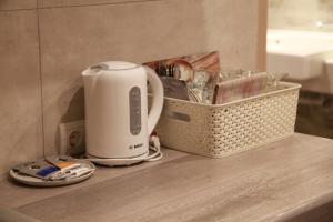 a toaster sitting on a counter next to a basket at WINE & ROSE BOUTIQUE HOTEL in Kharkiv