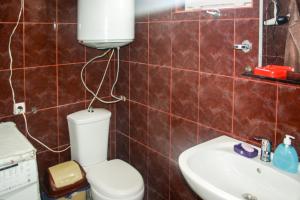 a bathroom with a toilet and a sink at Mshvidoba in Ushguli