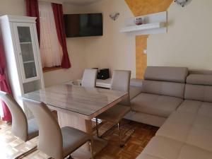 a living room with a table and a couch at TULPIKA 13 in Moravske-Toplice