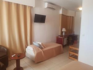 a hotel room with a bed and a television at Archotel in Dakar