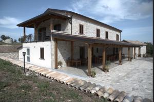 a large white building with a wooden roof at Agriturismo Il Parco in Nusco