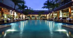 a large swimming pool in a building with chairs at PARKROYAL Saigon in Ho Chi Minh City