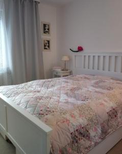 a bedroom with a bed with a quilt on it at Casa la Collina delle Ginestre in Eberbach