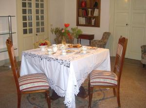a dining room table with a white table cloth on it at Villa De Pietro in Cursi