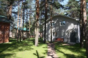 a house in the middle of a yard with trees at Karina in Vsevolozhsk