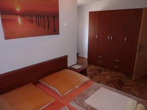 a room with a bed and a dresser in it at Cozy apartments near Queen beach Nin - Karlovacka I in Nin