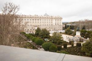 a large building with a garden in front of it at Hostal Central Palace Madrid in Madrid