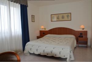 Postel nebo postele na pokoji v ubytování Hotel Rosamarina
