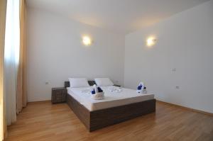 a bedroom with a large bed with white sheets at Guest House ASK in Primorsko +62 photos