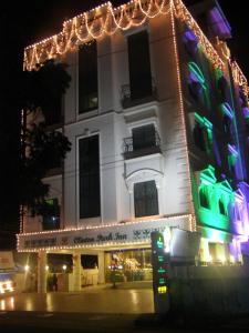 a building with christmas lights in front of it at Clinton Park Inn in Velankanni