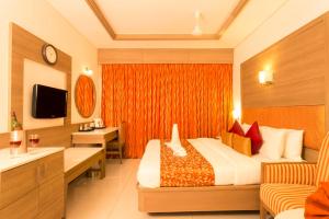 a hotel room with a bed and a sink at Clinton Park Inn in Velankanni