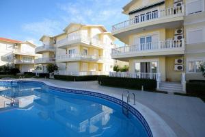 Villa con piscina frente a un edificio en Cleodora Residence, en Belek