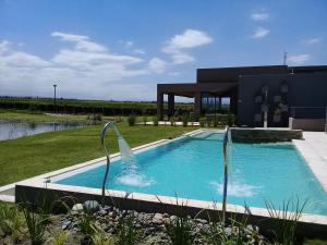 a swimming pool in front of a house at Casa Petrini in Tupungato