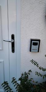 a door with a phone on the side of it at Aurora Premium Home in Győr