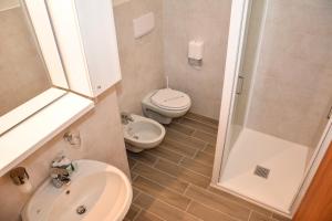 a bathroom with a toilet and a sink and a shower at Locanda Bella Italia in Castelnuovo del Garda +30 photos