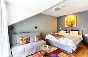 a bedroom with a bed and a couch at Stylish and High-end Designer Apartments in City Center in Sofia