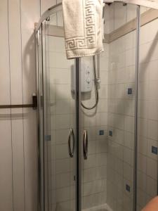 a bathroom with a shower with a towel on it at Impala Guest House in Wick