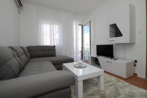 a living room with a couch and a table at Luxury Apartment Stefan in Sveti Stefan