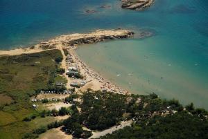 an aerial view of a beach with a crowd of people at Željko Apartmani in Lopar