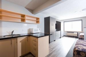 a kitchen with a sink and a counter top at Residence & Conference Centre - Kitchener-Waterloo in Kitchener