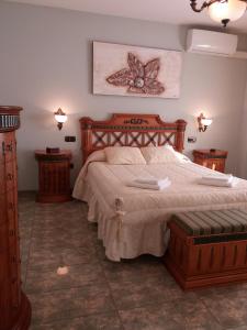 a bedroom with a large bed and two night stands at Quevoy in Alcañiz