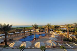 an aerial view of a resort with a pool and umbrellas at Park Inn by Radisson Abu Dhabi Yas Island in Abu Dhabi