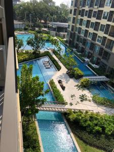 een uitzicht over een zwembad in een gebouw bij rain condo 2 bedroom by leelawadee in Cha Am