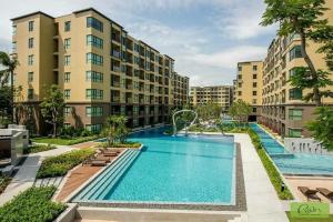 an apartment complex with a large swimming pool at rain condo Cha-am 2 bedroom by Napa in Cha Am +104 photos