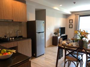 a kitchen with a stainless steel refrigerator and a table at rain condo Cha-am 2 bedroom by Napa in Cha Am