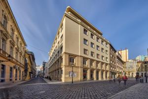 a large building on a street in a city at Pikachu's Gallery - historical old town Bratislava in Bratislava