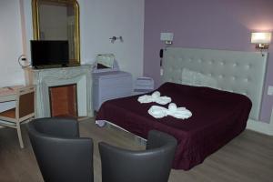 a bedroom with a bed with white flowers on it at Hotel restaurant MARTINEZ in Balaruc-les-Bains +13 photos