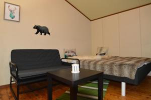a bedroom with a bed and a black bear on the wall at BaseCamp Birtavarre in Birtavarre