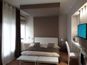 a bedroom with a large bed and a television at Rocca Di Monreale in Monreale