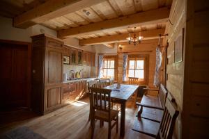 a kitchen with a table and chairs in a cabin at Chata u strýka Joža in Terchová