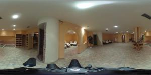 a large room with a lobby with a tile floor at Hotel Stella Montis in Campitello di Fassa